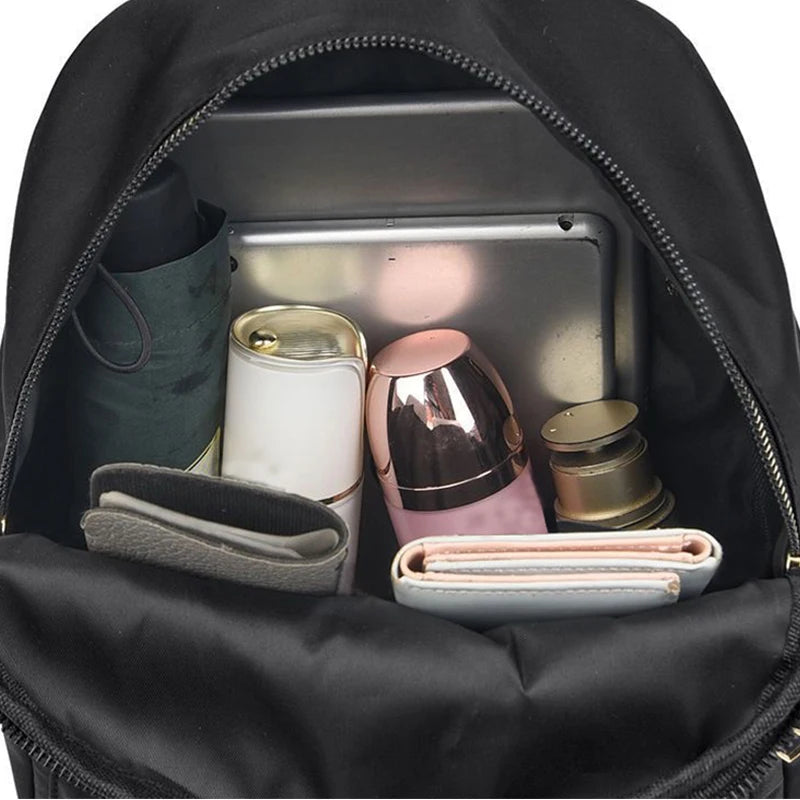 Women's large capacity backpack, made of durable fabric, with a zipper closure, suitable for traveling, parties and shopping